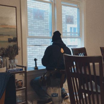 Creative Exteriors - a man sitting at a table in a living room - General Contractors Near Me - Chicago, Illinois Creative Exteriors - a man sitting at a table in a living room - General Contractors Near Me - Chicago, Illinois