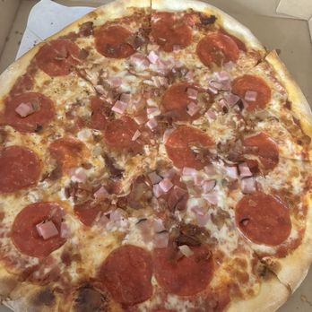 Pizza Cave - Crust and sauce are solid, ham and uncooked bacon only in the middle. - Italian Near Me - Dripping Springs, Texas Pizza Cave - Crust and sauce are solid, ham and uncooked bacon only in the middle. - Italian Near Me - Dripping Springs, Texas