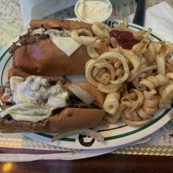 Flanigan's - Philly cheesesteak w/ curly fries - Sports Bars Near Me - Miramar, Florida Flanigan's - Philly cheesesteak w/ curly fries - Sports Bars Near Me - Miramar, Florida