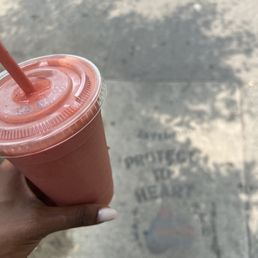 a hand holding a smoothie a hand holding a smoothie