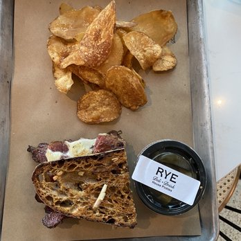 Rye Deli & Drink - 1/2 Pastrami Reuben (way to salty) w/kettle chips (very good), salty pickles - Delis Near Me - Chicago, Illinois