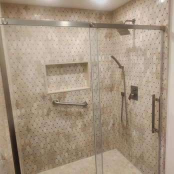 STS Renovation - a walk - in shower with a glass door - General Contractors Near Me