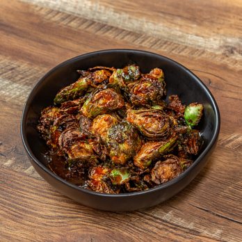 Yard - Crispy Brussels sprouts tossed in Yard's signature Scotched Kiss glaze, bringing bold Caribbean flavor to a popular side dish. - Caribbean Near Me - Baltimore, Maryland Yard - Crispy Brussels sprouts tossed in Yard's signature Scotched Kiss glaze, bringing bold Caribbean flavor to a popular side dish. - Caribbean Near Me - Baltimore, Maryland
