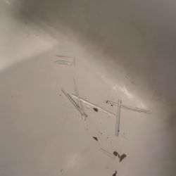 Max & Co. - Broken charts of glass and tile from the shower door, falling off the racks