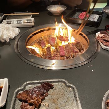 Chubby Cattle - Our server helping cook some of the meats. Since it was fatty, the flames would get a little out of control - Barbeque Near Me - Cerritos, California Chubby Cattle - Our server helping cook some of the meats. Since it was fatty, the flames would get a little out of control - Barbeque Near Me - Cerritos, California