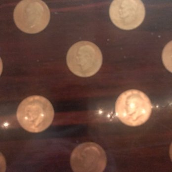 Foresters Club - a wooden table with a lot of coins on it - Cocktail Bars Near Me - McCall, Idaho Foresters Club - a wooden table with a lot of coins on it - Cocktail Bars Near Me - McCall, Idaho