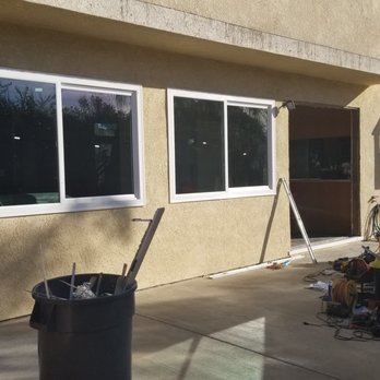 Ameriside - two living room windows, sliding door in progress, and visible kitchen garden window - Windows Installation Near Me - Lake Forest, California Ameriside - two living room windows, sliding door in progress, and visible kitchen garden window - Windows Installation Near Me - Lake Forest, California