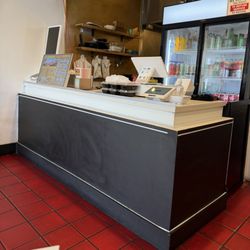 The order counter with cold beverages in that fridge