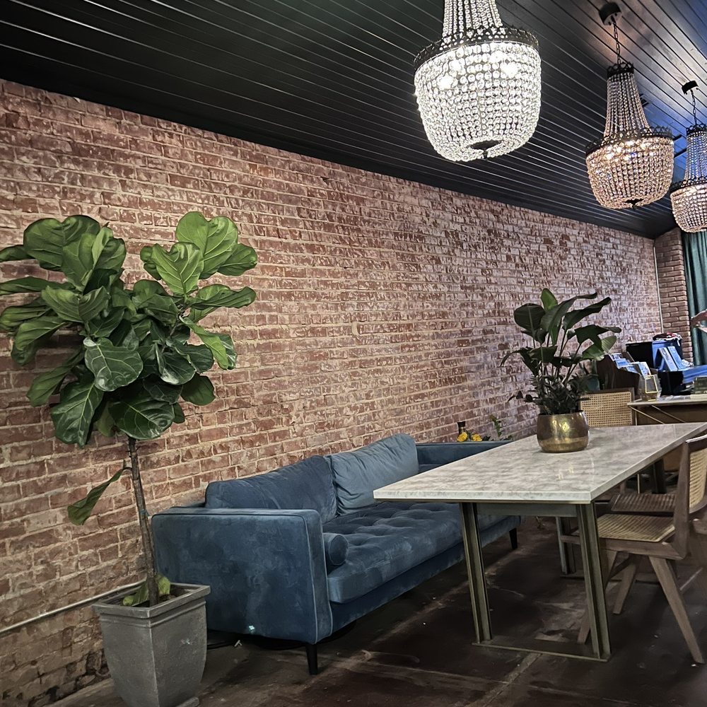 Round Midnight - a dining room with a brick wall and blue couches - Speakeasies Near Me - Edmond, Oklahoma Round Midnight - a dining room with a brick wall and blue couches - Speakeasies Near Me - Edmond, Oklahoma