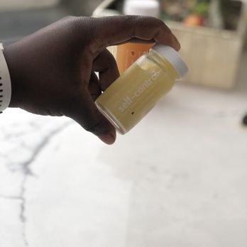 Beraka Juice - a hand holding a bottle of juice - Juice Bars & Smoothies Near Me - Winthrop, Massachusetts