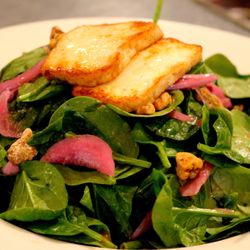 Laili Restaurant - Our spinach salad features fresh, tender spinach paired with warm, golden halloumi cheese, creating a delightful contrast of textures.