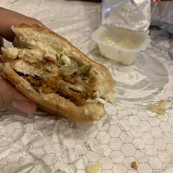 Wendy's - a hand holding a half eaten sandwich - Burgers Near Me - Dallas, Texas