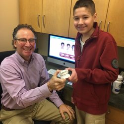 Margolis Orthodontics - Wilbraham - Dr. Margolis is presenting Cameron with the mold of his old teeth.
