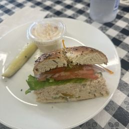 Tuna fish sandwich on an everything bagel with potato salad Tuna fish sandwich on an everything bagel with potato salad