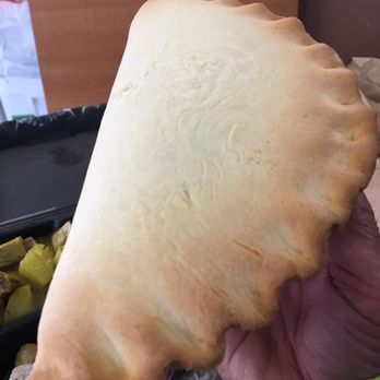 Pasifica Corned Beef Kitchen - a hand holding a piece of bread - Polynesian Near Me - Magna, Utah