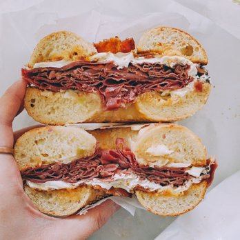 Bagel Nosh & Deli - Udoff (corned beef, pastrami, bacon, mozzarella, coleslaw and Russian prepared "reuben style") on a sesame bagel - Bagels Near Me - West Windsor, New Jersey Bagel Nosh & Deli - Udoff (corned beef, pastrami, bacon, mozzarella, coleslaw and Russian prepared "reuben style") on a sesame bagel - Bagels Near Me - West Windsor, New Jersey