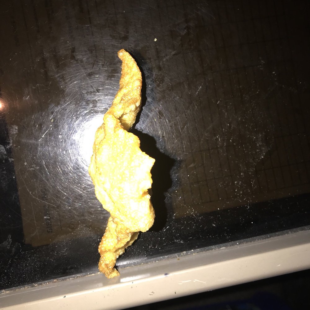 a piece of fried chicken on a window sill