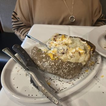 Arthur's Prime Steakhouse - The loaded baked potato is massive and can easily be split between two adult, or one adult and 2 bad children. - Steakhouses Near Me - Little Rock, Arkansas
