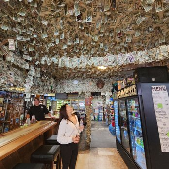 Turtle Rock - a woman standing in front of a bar with money hanging from the ceiling - Beer, Wine & Spirits Near Me - Napa, California Turtle Rock - a woman standing in front of a bar with money hanging from the ceiling - Beer, Wine & Spirits Near Me - Napa, California