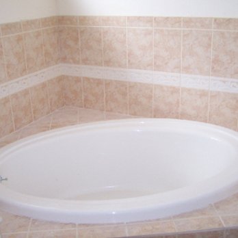 Done Right Contracting - a bathtub in a tiled bathroom - General Contractors Near Me - Palm Bay, Florida Done Right Contracting - a bathtub in a tiled bathroom - General Contractors Near Me - Palm Bay, Florida