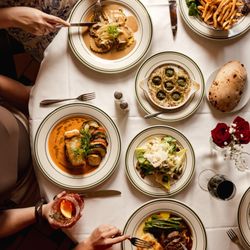 Table of food: escargot, salad, salmon