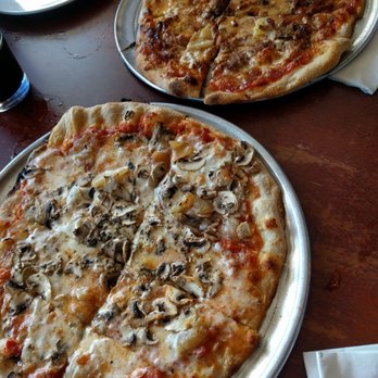 Flatbread Company - Mopsy's Kalua Pork (back) and Pa'ia Bay Ohana (front) - $15.50 and $14.50 respectively - 12 inches each - Pizza Near Me - Paia, Hawaii