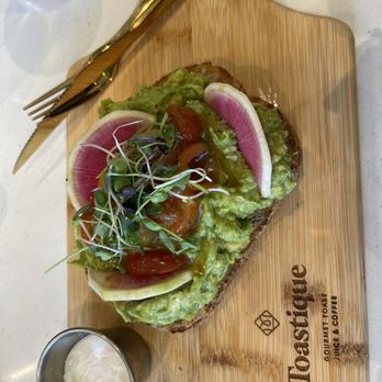Toastique - Avocado toast with radish, tomatoes and alfalfa, with a poached egg on the side. - Juice Bars & Smoothies Near Me - Henderson, Nevada Toastique - Avocado toast with radish, tomatoes and alfalfa, with a poached egg on the side. - Juice Bars & Smoothies Near Me - Henderson, Nevada