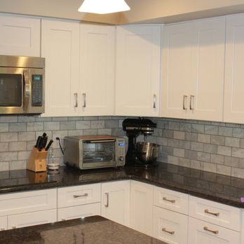 Rose Tree Construction - a kitchen with granite countertops and white cabinets - General Contractors Near Me - Media, Pennsylvania Rose Tree Construction - a kitchen with granite countertops and white cabinets - General Contractors Near Me - Media, Pennsylvania