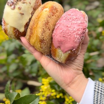 La Forêt - Royal Oak - a hand holding three donuts - Donuts Near Me - Burnaby, British Columbia La Forêt - Royal Oak - a hand holding three donuts - Donuts Near Me - Burnaby, British Columbia