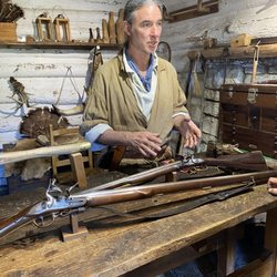 Interpreter explains the making of early weapons.