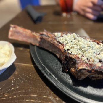 The Pier House - 36 ounce tomahawk with blue cheese crumbles - Steakhouses Near Me - Daytona Beach, Florida The Pier House - 36 ounce tomahawk with blue cheese crumbles - Steakhouses Near Me - Daytona Beach, Florida
