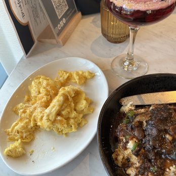 The Breakfast Club - Grits & Oxtails scrambled eggs the drink is Cab Calloway - Breakfast & Brunch Near Me - Silver Spring, Maryland