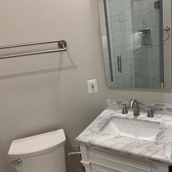 I4 Construction - a bathroom with a sink, toilet, and shower - General Contractors Near Me