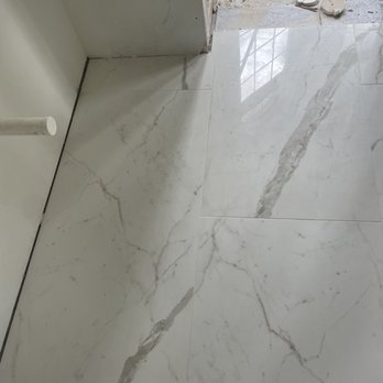 FloorSRQ - a white marble floor in a bathroom - Flooring Near Me - Sarasota, Florida
