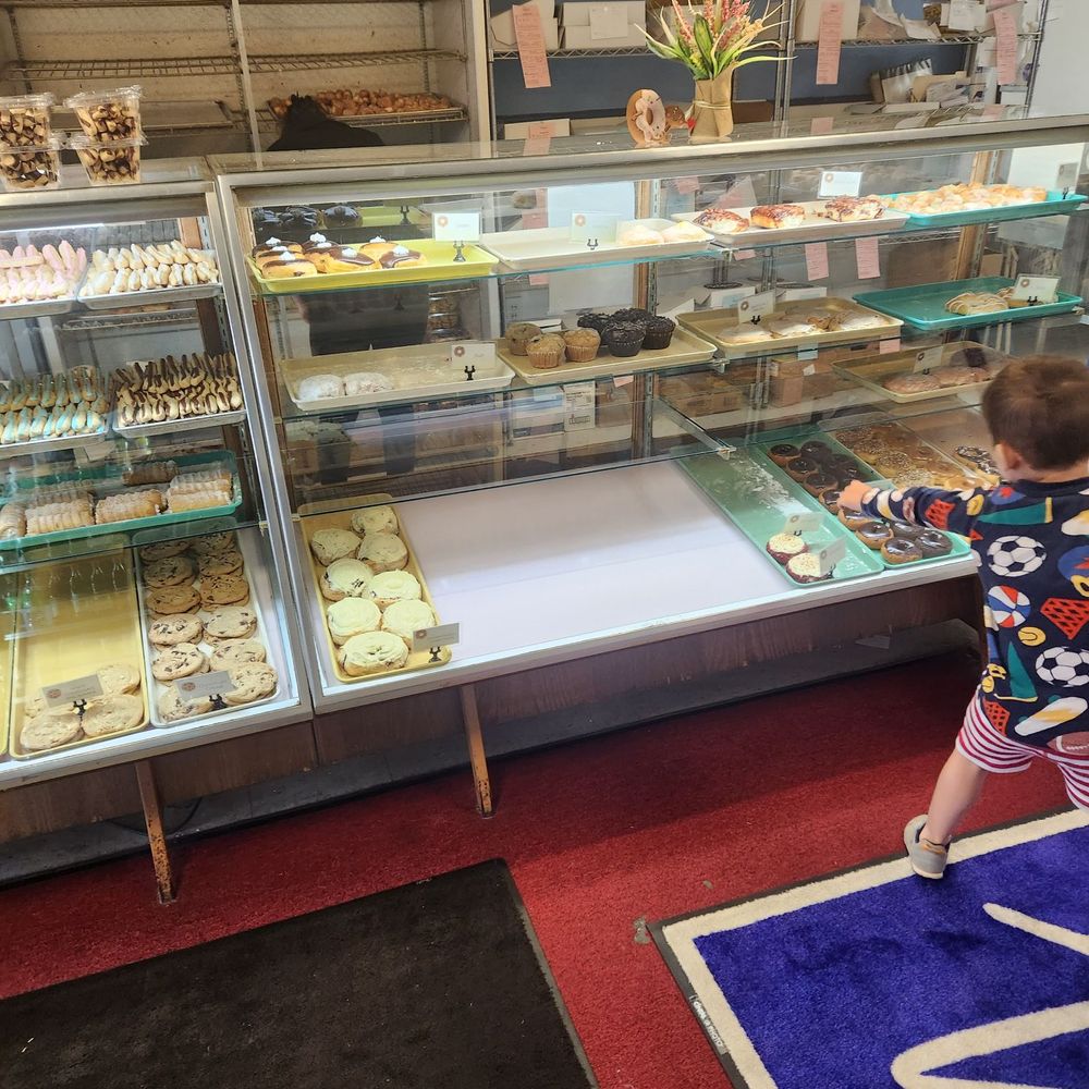 Wilson's Bakery - a toddler in front of a display of pastries - Bakeries Near Me - Warner Robins, Georgia