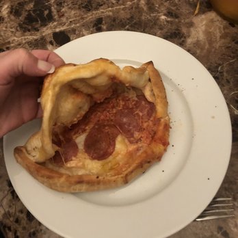 Mossimo's Pizza & Subs - a hand holding a piece of pizza - Pizza Near Me - Pelham, Ontario Mossimo's Pizza & Subs - a hand holding a piece of pizza - Pizza Near Me - Pelham, Ontario