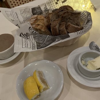 Chez Pierre - a basket of bread and butter on a table - French Near Me - Palm Desert, California