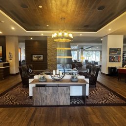 View from the entryway with the front desk on the left, seating area in the middle, and bar/spacious restaurant to the right. View from the entryway with the front desk on the left, seating area in the middle, and bar/spacious restaurant to the right.