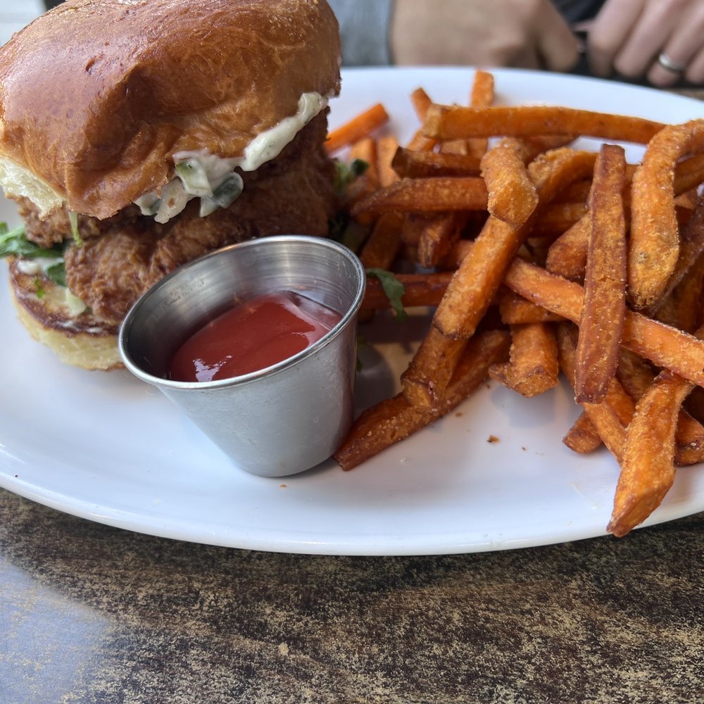 CIRCA at Navy Yard - FRIED CHICKEN SANDWICH - shredded lettuce, dill pickles, dill pickle aioli, brioche bun, sweet potato fries $15 - American Near Me - Washington, DC, District of Columbia CIRCA at Navy Yard - FRIED CHICKEN SANDWICH - shredded lettuce, dill pickles, dill pickle aioli, brioche bun, sweet potato fries $15 - American Near Me - Washington, DC, District of Columbia