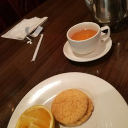 Tea with almond cookies and orange slices. Tea with almond cookies and orange slices.