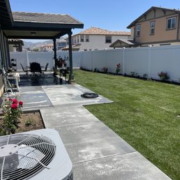 a backyard with a patio and a large air conditioner a backyard with a patio and a large air conditioner