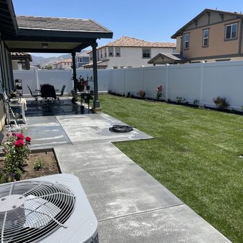 Ceron Landscaping - a backyard with a patio and a large air conditioner - Tree Services Near Me Ceron Landscaping - a backyard with a patio and a large air conditioner - Tree Services Near Me