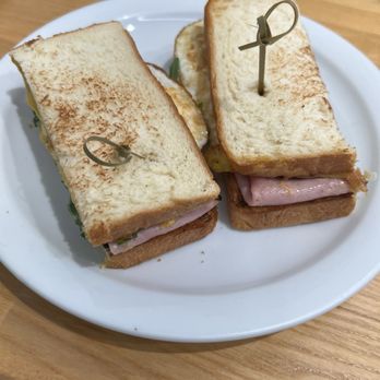 Cafe Dulce - breakfast sandwich. ham, egg cheese, some salad type leaves in there. Not sure. And I think they add their house made sauce. 10/10 - Cafes Near Me - Vernon, California