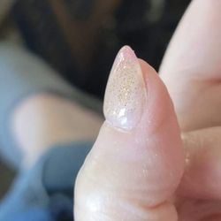 A Nails & Beauty Supply - This shows the right corner of my thumbnail bed with an uneven bump and no gold glitter nailpolish.
