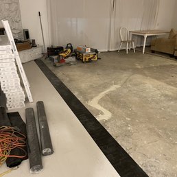 Day 1 completed removal of carpet, kitchen tiles, floor prep, and start of new flooring