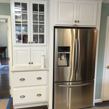 JLC Construction - a stainless steel refrigerator in a kitchen - General Contractors Near Me JLC Construction - a stainless steel refrigerator in a kitchen - General Contractors Near Me
