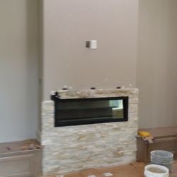 Gallardo's Construction and painting - Adding faux stone to decorate this fire place.