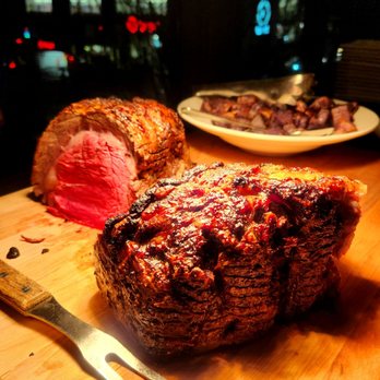 Muse at Benaroya Hall - a large roast of beef with a knife and fork on a cutting board - New American Near Me - Seattle, Washington Muse at Benaroya Hall - a large roast of beef with a knife and fork on a cutting board - New American Near Me - Seattle, Washington
