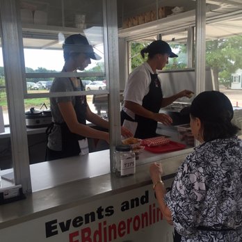 EB Diner - a woman ordering food from a counter - Food Trucks Near Me EB Diner - a woman ordering food from a counter - Food Trucks Near Me