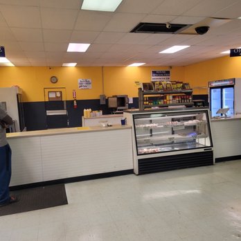 Crab King - a man standing in front of a counter - Seafood Near Me - Augusta, Georgia Crab King - a man standing in front of a counter - Seafood Near Me - Augusta, Georgia